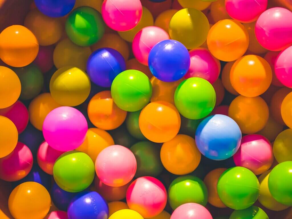 plastic balls in orange, blue, green and pink