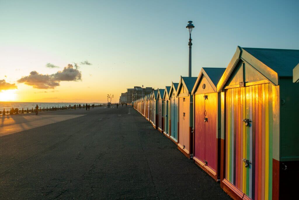 Colourful cabins on Brighton seaside at sunset