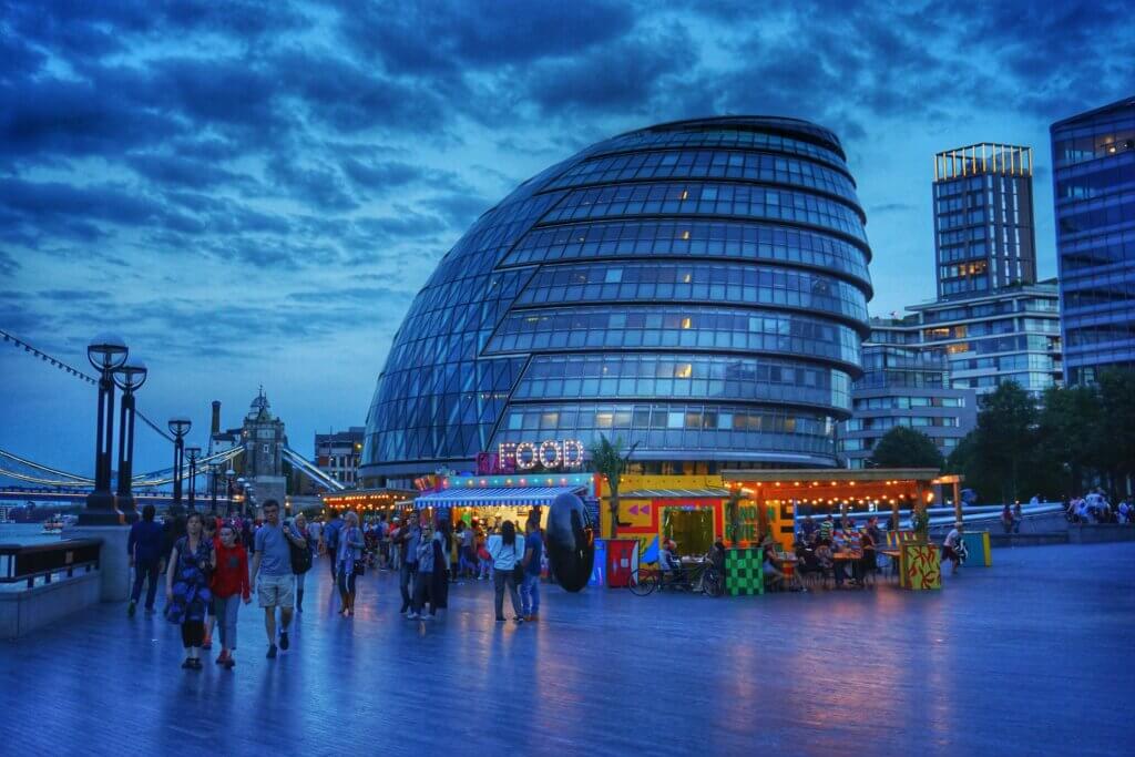 London City Council by night with some street food stalls in front of it
