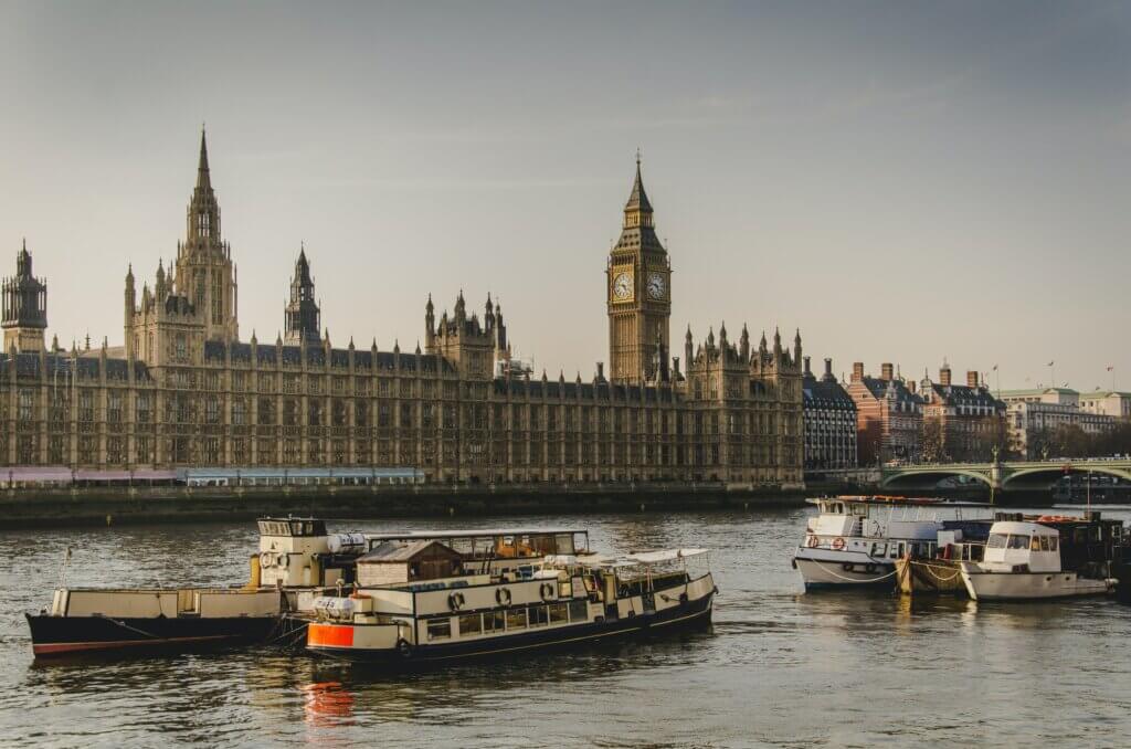 View of Westminster Parliament from the River Thames teeming with boats