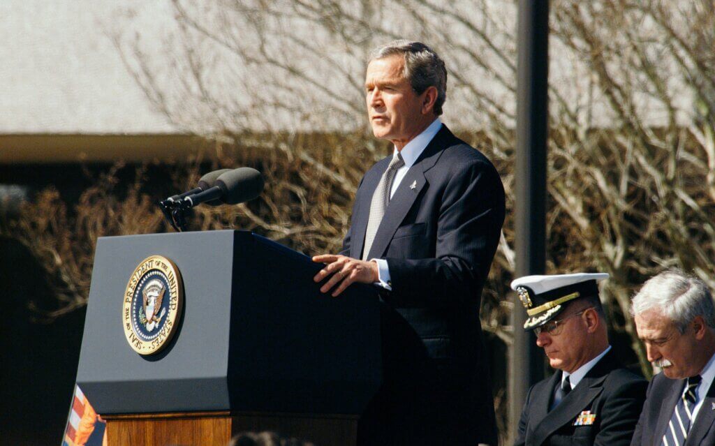 Ex-President Bush making a speech on a podium