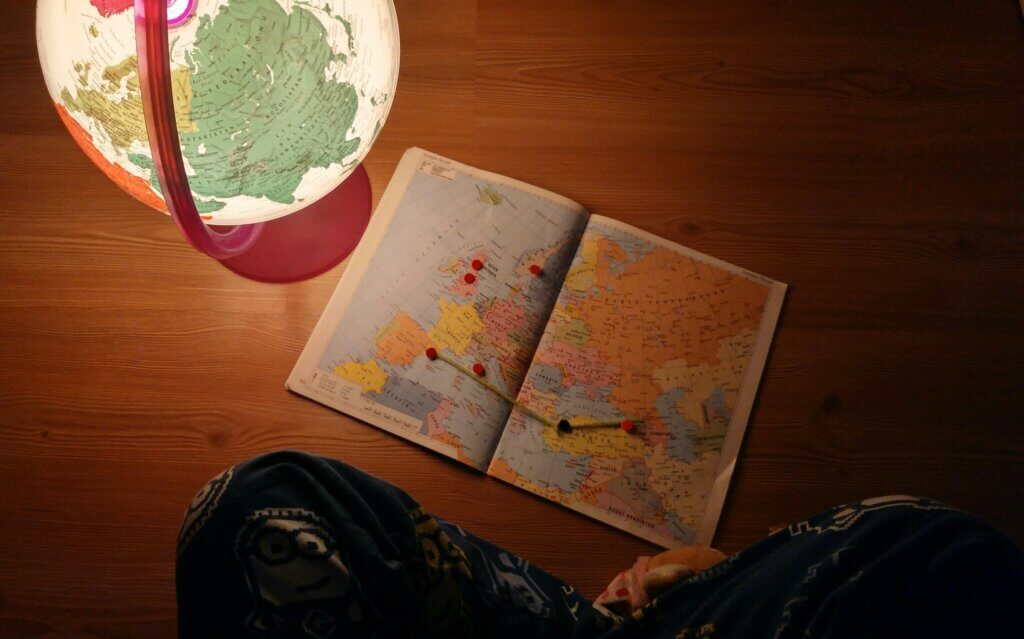 An image of a map and a globe on a table