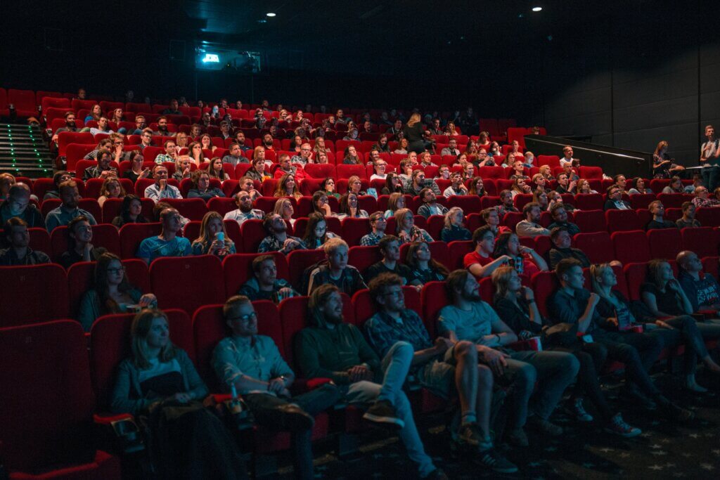 People sat watching a film at a cinema in East London